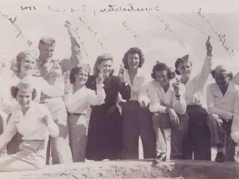 1943 photo of several women in military uniforms waving